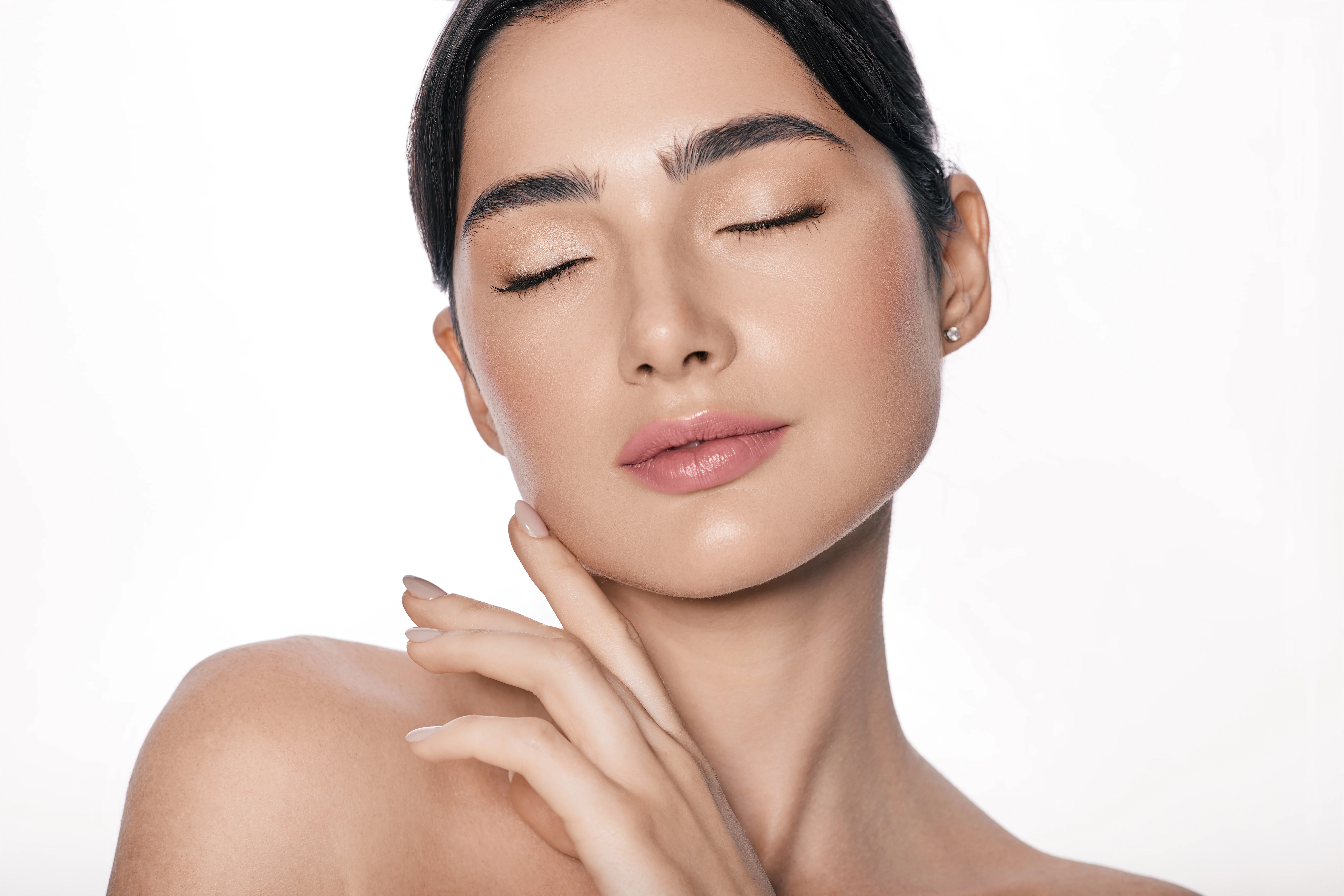 Woman with a towel wrapped around her hair preparing for a skin treatment